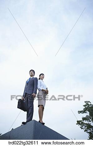 Businessmen standing with briefcase and planner View Large Photo Image Stock Image - Businessmen standing with briefcase and planner. Fotosearch