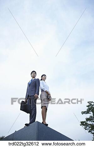 Businessmen standing with briefcase and planner View Large Photo Image Stock Image - Businessmen standing with briefcase and planner. Fotosearch