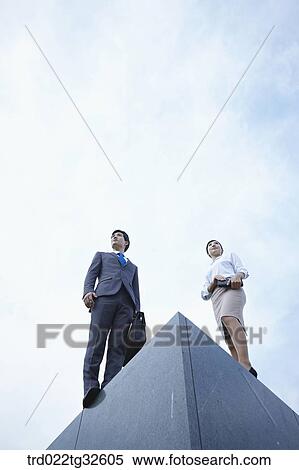 Businessmen standing with briefcase and planner View Large Photo Image Stock Photography - Businessmen standing with briefcase and planner. Fotosearch