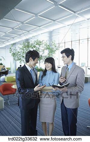 Stock Image - Businessmen talking in the lounge. Fotosearch