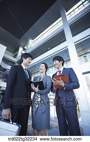 Picture - Businessmen with suitcase, planner, and document file. Fotosearch