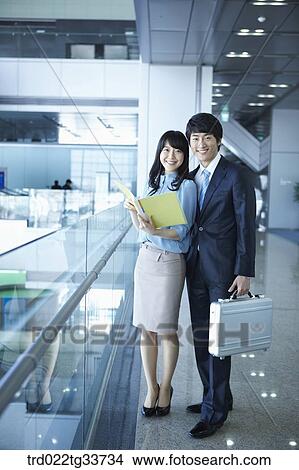 Picture - Businessmen with the file and briefcase. Fotosearch
