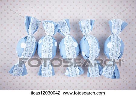 Candy in blue lace wrapping View Large Photo Image Stock Image - Candy in blue lace wrapping. Fotosearch