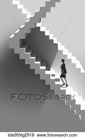 Stock Photo - career woman is going upstairs. Fotosearch