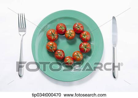 Stock Image - Cherry tomatoes in the heart shape. Fotosearch
