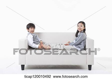 Children lying on the couch View Large Photo Image Stock Image - Children lying on the couch. Fotosearch