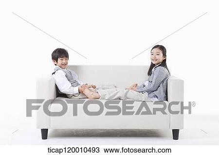 Children lying on the couch View Large Photo Image Stock Image - Children lying on the couch. Fotosearch