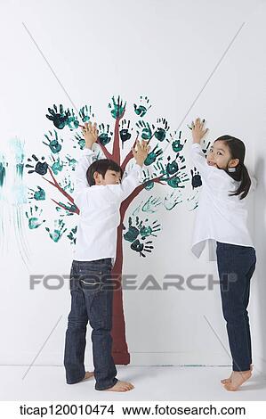Children painting the tree with hands View Large Photo Image Picture - Children painting the tree with hands. Fotosearch