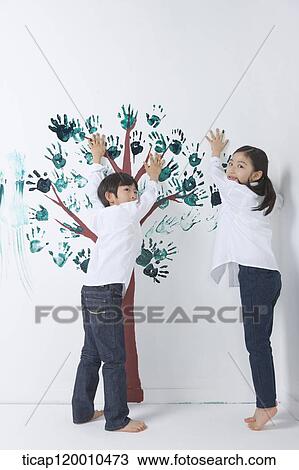 Children painting the tree with hands View Large Photo Image Stock Image - Children painting the tree with hands. Fotosearch