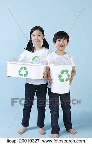 Children smiling with recycling bin View Large Photo Image Stock Photo - Children smiling with recycling bin . Fotosearch