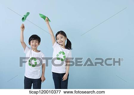 Stock Photo - Children wearing recycling shirt with green pinwheel. Fotosearch