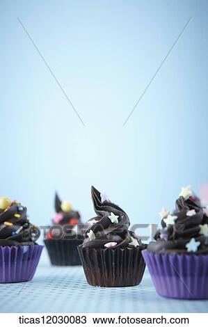 Chocolate cupcake with colorful decoration View Large Photo Image Stock Image - Chocolate cupcake with colorful decoration . Fotosearch