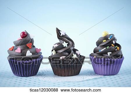 Chocolate cupcake with colorful decoration View Large Photo Image Stock Photo - Chocolate cupcake with colorful decoration . Fotosearch