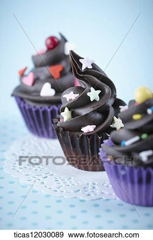 Chocolate cupcake with colorful decoration View Large Photo Image Stock Photo - Chocolate cupcake with colorful decoration . Fotosearch