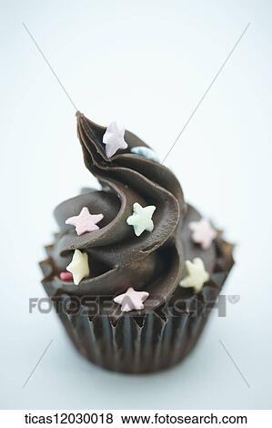 Chocolate cupcake with star decoration View Large Photo Image Stock Photo - Chocolate cupcake with star decoration . Fotosearch
