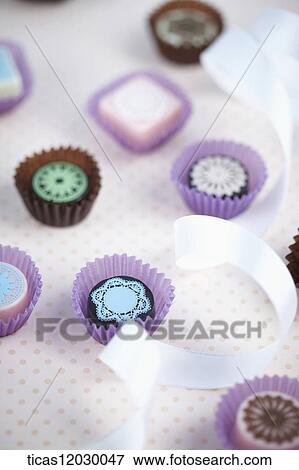 Chocolate with white ribbon View Large Photo Image Stock Photo - Chocolate with white ribbon . Fotosearch