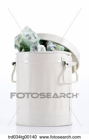 Stock Image - crumpled money bills in waste bucket. Fotosearch