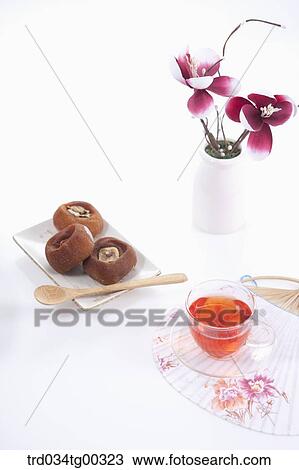 Dries persimmons, a cup of tea, a fan, and flowers View Large Photo Image Stock Image - Dries persimmons, a cup of tea, a fan, and flowers. Fotosearch