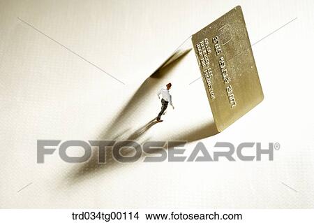 figures stood under the credit cards View Large Photo Image Picture - figures stood under the credit cards. Fotosearch