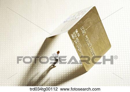 Stock Image - figures stood under the credit cards. Fotosearch