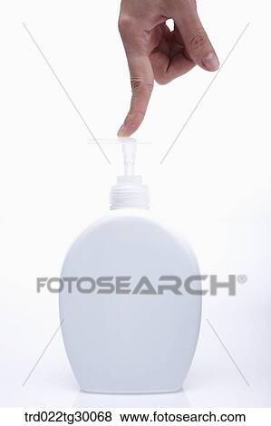 Stock Photo - finger pushes pump of liquid soap. Fotosearch