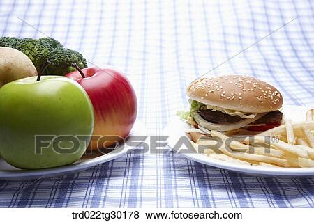 Fresh vegetable and junk food on dish View Large Photo Image Stock Photo - Fresh vegetable and junk food on dish . Fotosearch