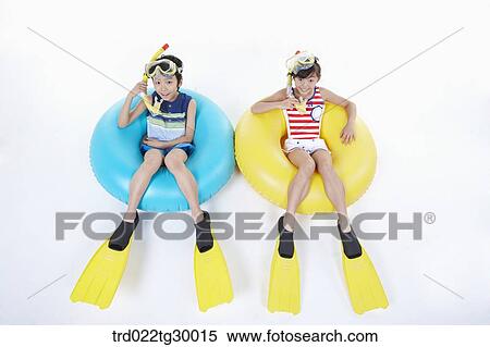 girl and boy are sitting on the tube with snorkels and tube and flippers View Large Photo Image Stock Photography - girl and boy are sitting on the tube with snorkels and tube and flippers. Fotosearch