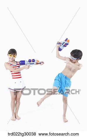 girl is holding water gun on boy View Large Photo Image Stock Photo - girl is holding water gun on boy. Fotosearch