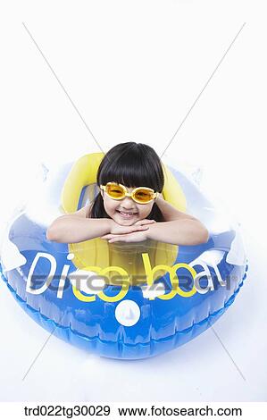Stock Photo - girl is lying face down on the boat. Fotosearch