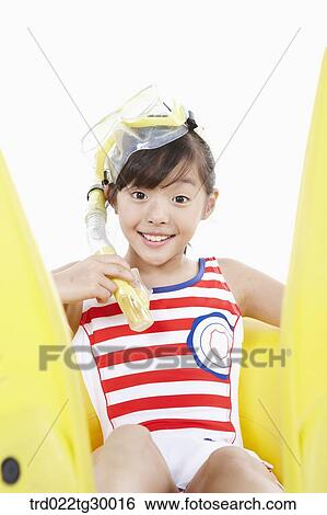 Stock Photograph - girl is sitting on the tube with snorkel and flippers. Fotosearch
