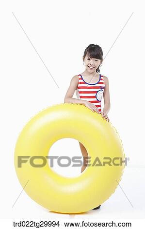 girl is standing with holding beach ball View Large Photo Image Picture - girl is standing with holding beach ball. Fotosearch
