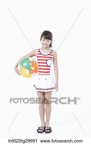 girl is standing with holding beach ball in her arm View Large Photo Image Stock Image - girl is standing with holding beach ball in her arm. Fotosearch