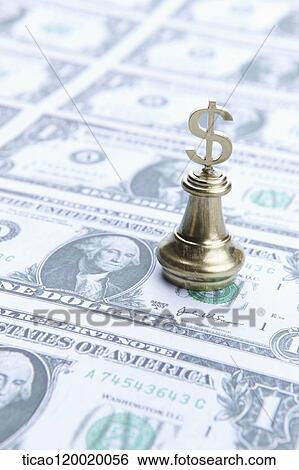 Stock Photograph - Golden dollar chess piece on the dollar. Fotosearch