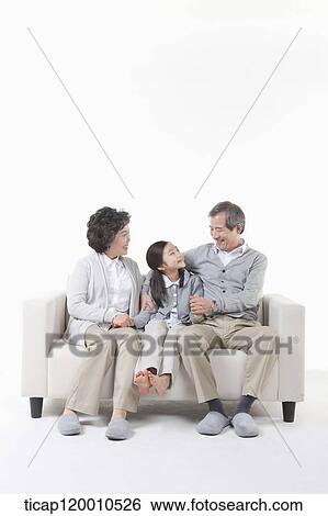 Grandparents and granddaughter on the couch View Large Photo Image Stock Photograph - Grandparents and granddaughter on the couch. Fotosearch