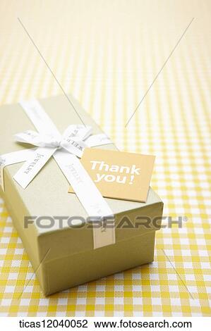 Stock Image - Green gift box with white ribbon . Fotosearch