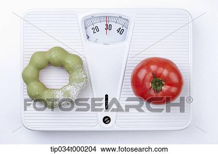 Green tea donut and tomato on the scale View Large Photo Image Picture - Green tea donut and tomato on the scale. Fotosearch