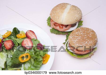 Hamburger and salad View Large Photo Image Stock Photo - Hamburger and salad. Fotosearch