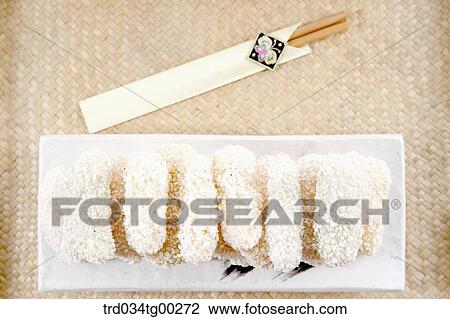 Stock Image - Korean dessert on dish and chopsticks. Fotosearch