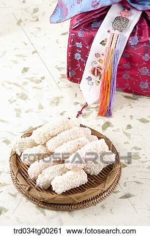 Stock Image - Korean dessert with red traditonal wrapped package. Fotosearch