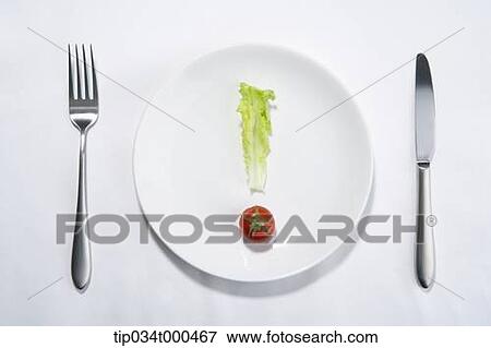 Stock Photo - Lettuce and cherry tomato in the exclamation shape. Fotosearch