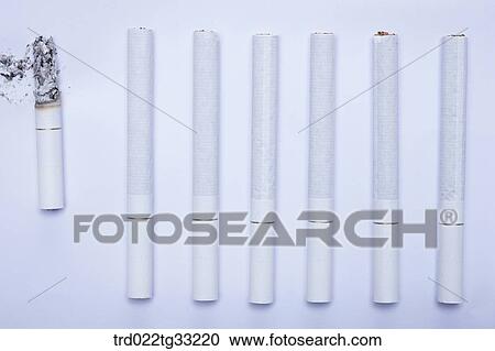 Long cigarettes and a short cigarette View Large Photo Image Stock Image - Long cigarettes and a short cigarette. Fotosearch