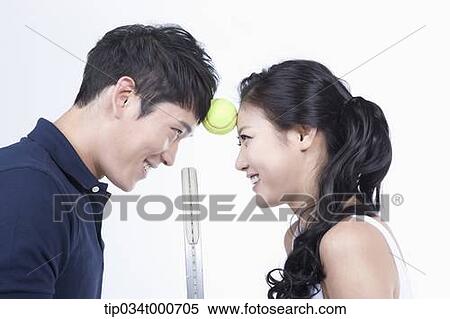 Male and female tennis players between a ball View Large Photo Image Stock Photography - Male and female tennis players between a ball. Fotosearch