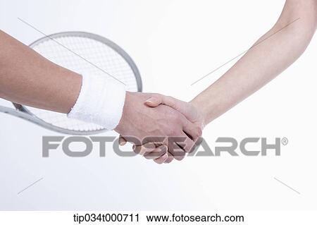 Male and female tennis players shaking hands View Large Photo Image Stock Image - Male and female tennis players shaking hands. Fotosearch