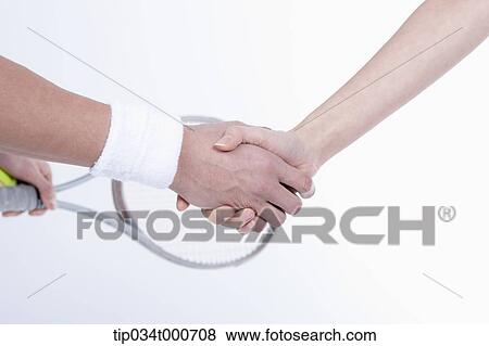 Male and female tennis players shaking hands View Large Photo Image Stock Photo - Male and female tennis players shaking hands. Fotosearch