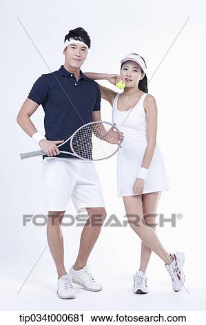 Stock Image - Male and female tennis players with a ball and racket. Fotosearch