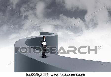 Stock Image - man is holding clock in his hand. Fotosearch