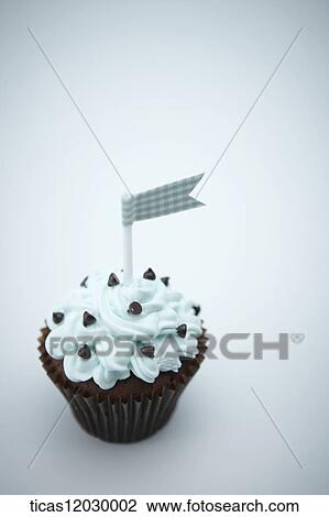 Stock Image - Mint chocolate cupcake with blue flag. Fotosearch