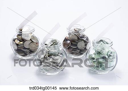 money bills and coins in glass bottle View Large Photo Image Stock Photography - money bills and coins in glass bottle. Fotosearch