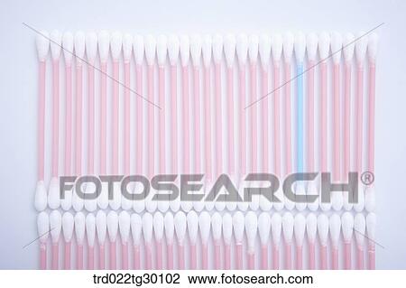 Stock Image - One blue cotton swab and other white cotton swab in a row. Fotosearch