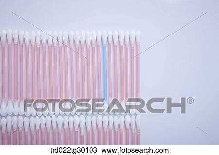 Stock Image - One blue cotton swab and other white cotton swab in a row. Fotosearch